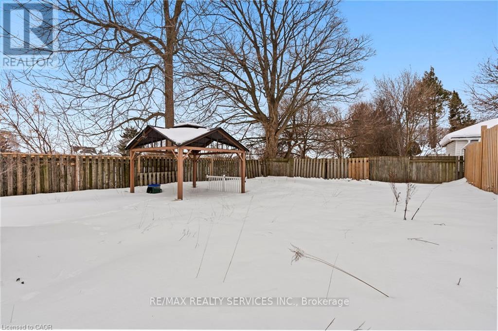 A gazebo sits in the middle of a snow-covered field.