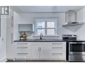 A kitchen with white cabinets and a stainless steel oven.