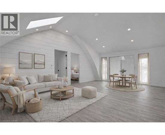 A modern living room with a skylight and a dining area.