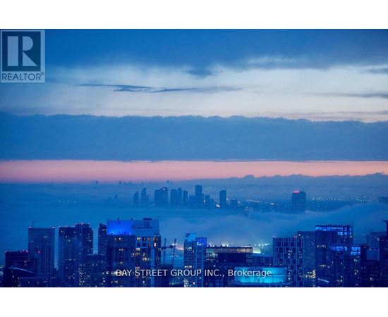 A cityscape at dusk with the Bay Street Group Inc. logo superimposed on the buildings.