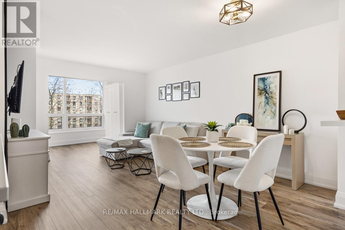 A white dining room with a table set for four.
