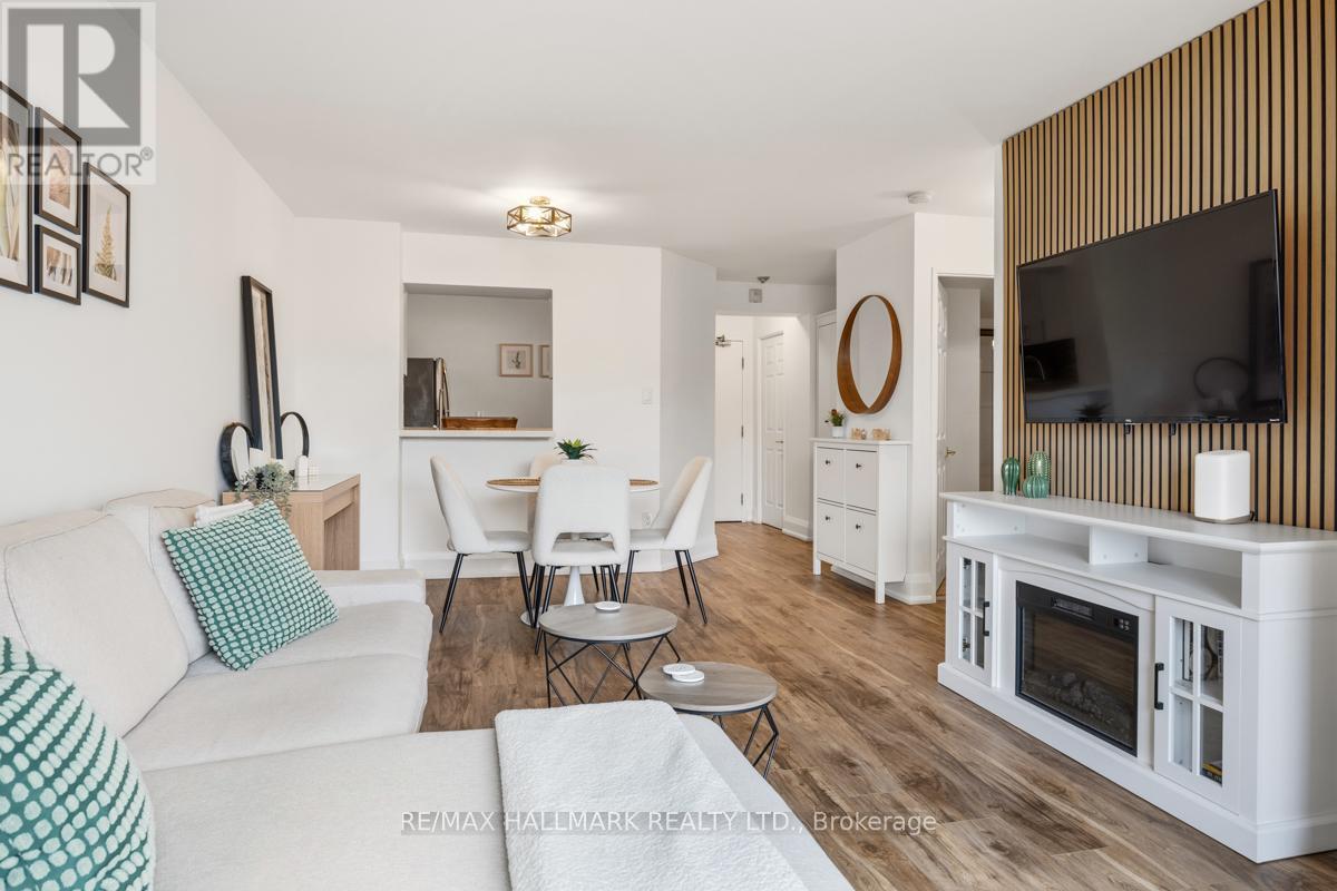 A living room with a white couch and a wooden wall.