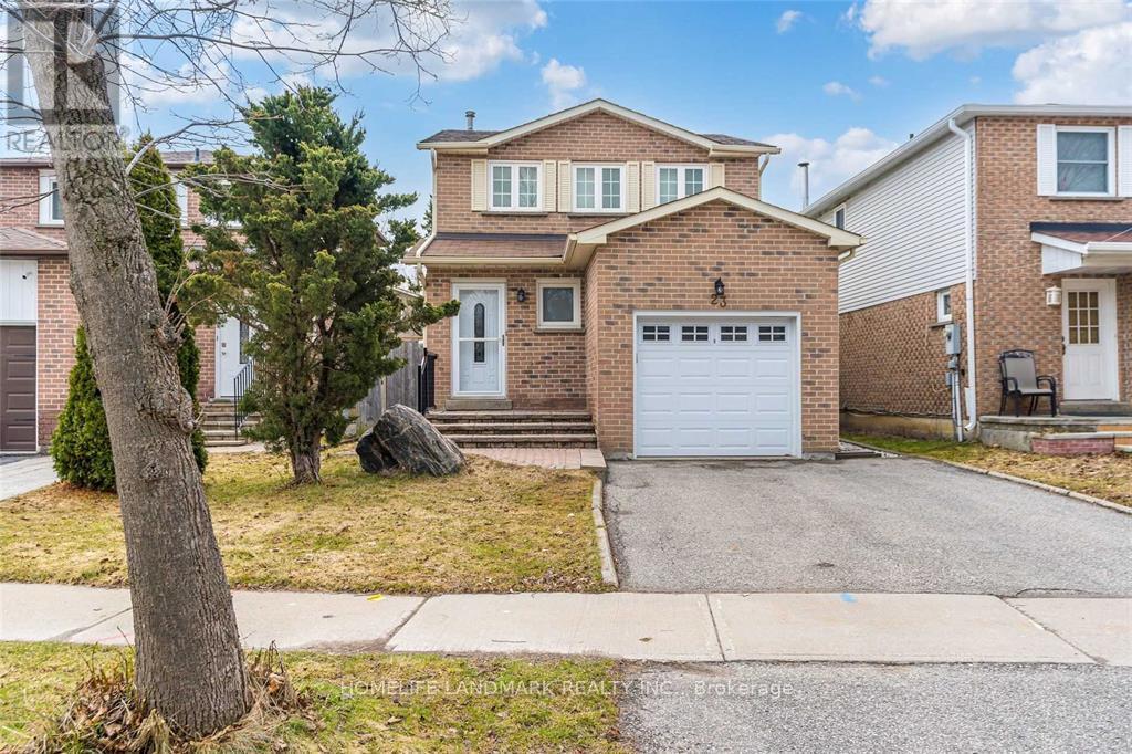 A house with a garage and a driveway in front of it.