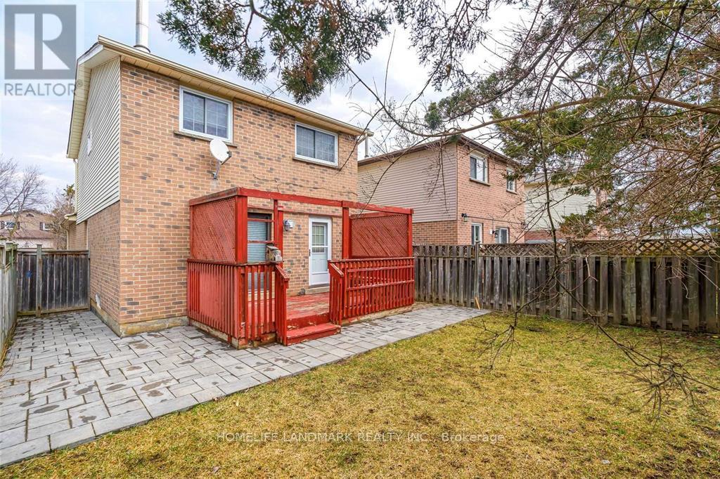 A red shed is in the front yard of a house.
