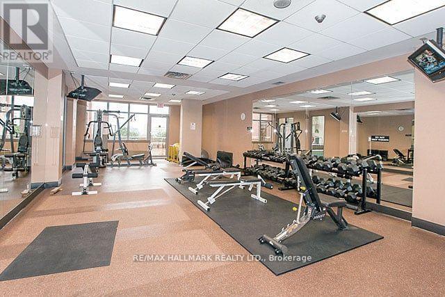 A gym with a variety of equipment including treadmills, weights, and exercise machines.