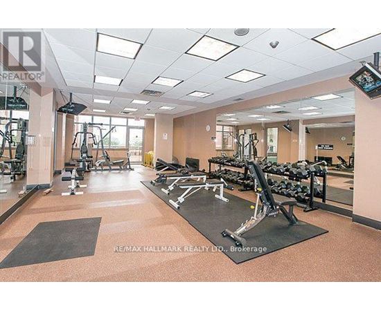 A gym with a variety of equipment including treadmills, weights, and exercise machines.