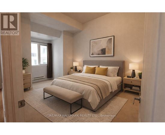 A bedroom with a large bed and a bench in front of it.