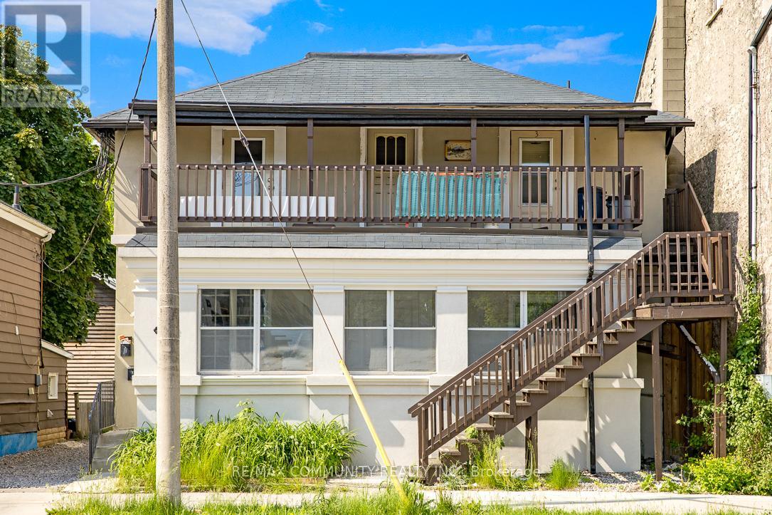A house with a balcony and stairs leading to the front door.