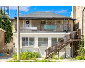 A house with a balcony and stairs leading to the front door.