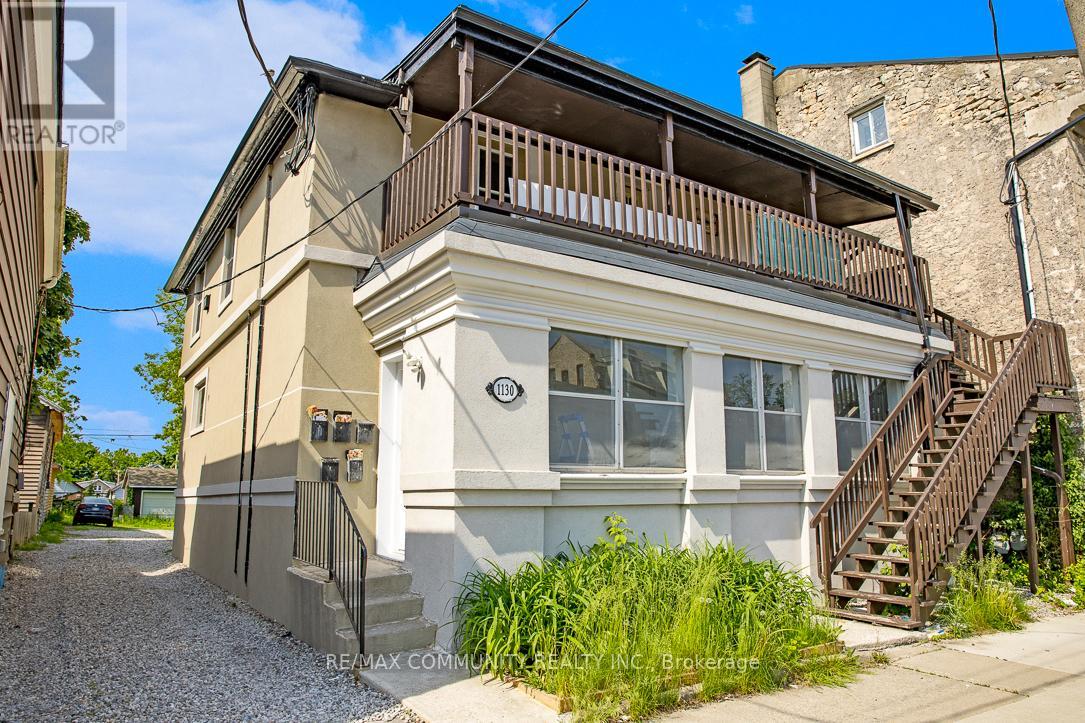 A two-story house with a balcony on the upper floor.