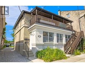 A two-story house with a balcony on the upper floor.