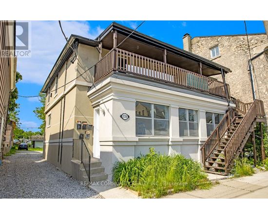 A two-story house with a balcony on the upper floor.