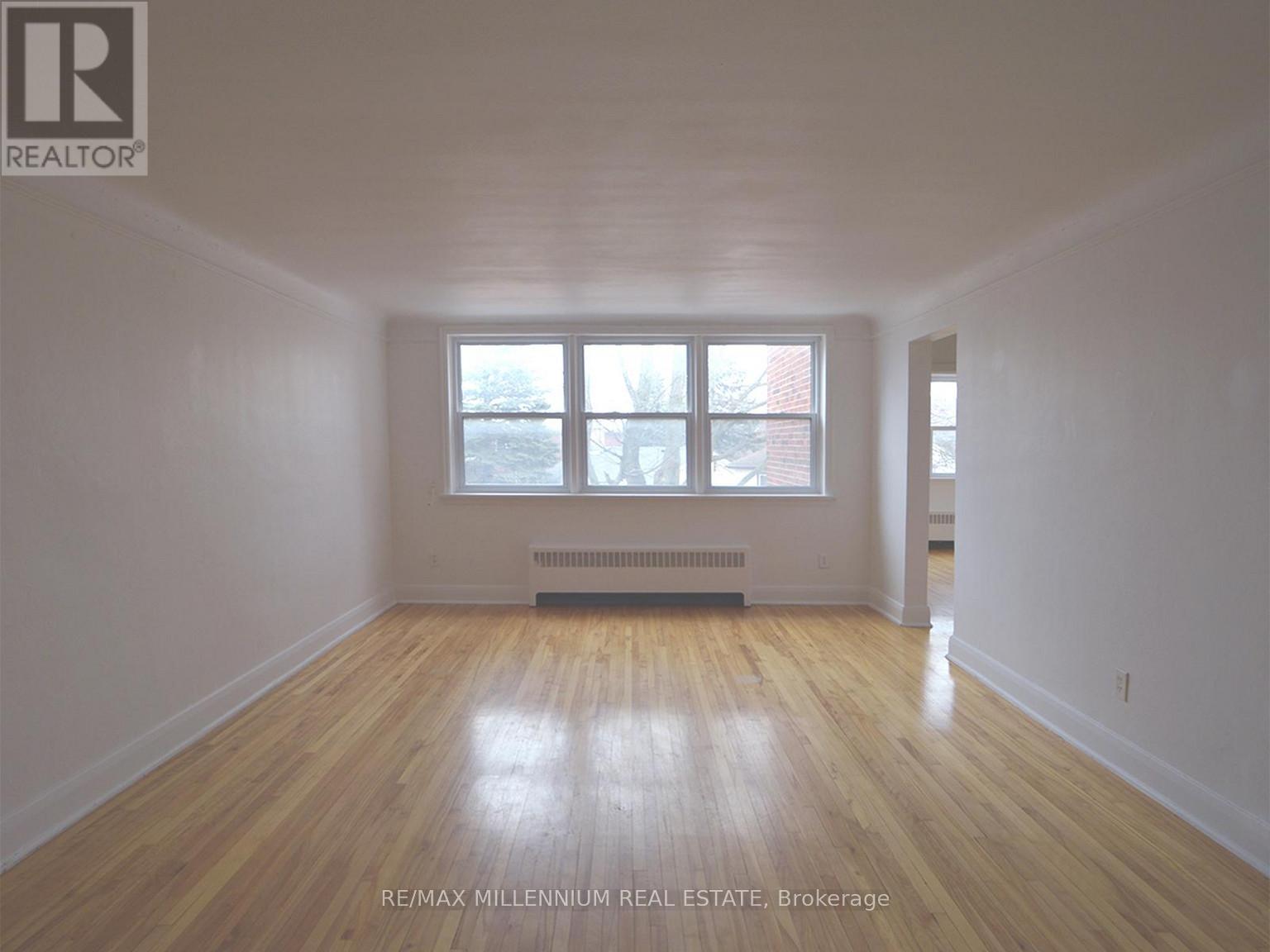 A room with wooden floors and a window.