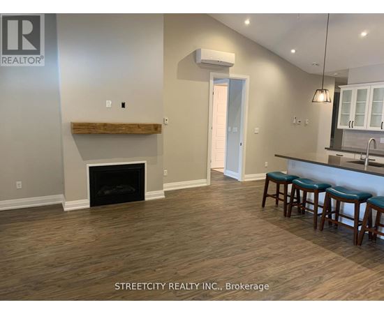 A living room with a fireplace and bar stools.