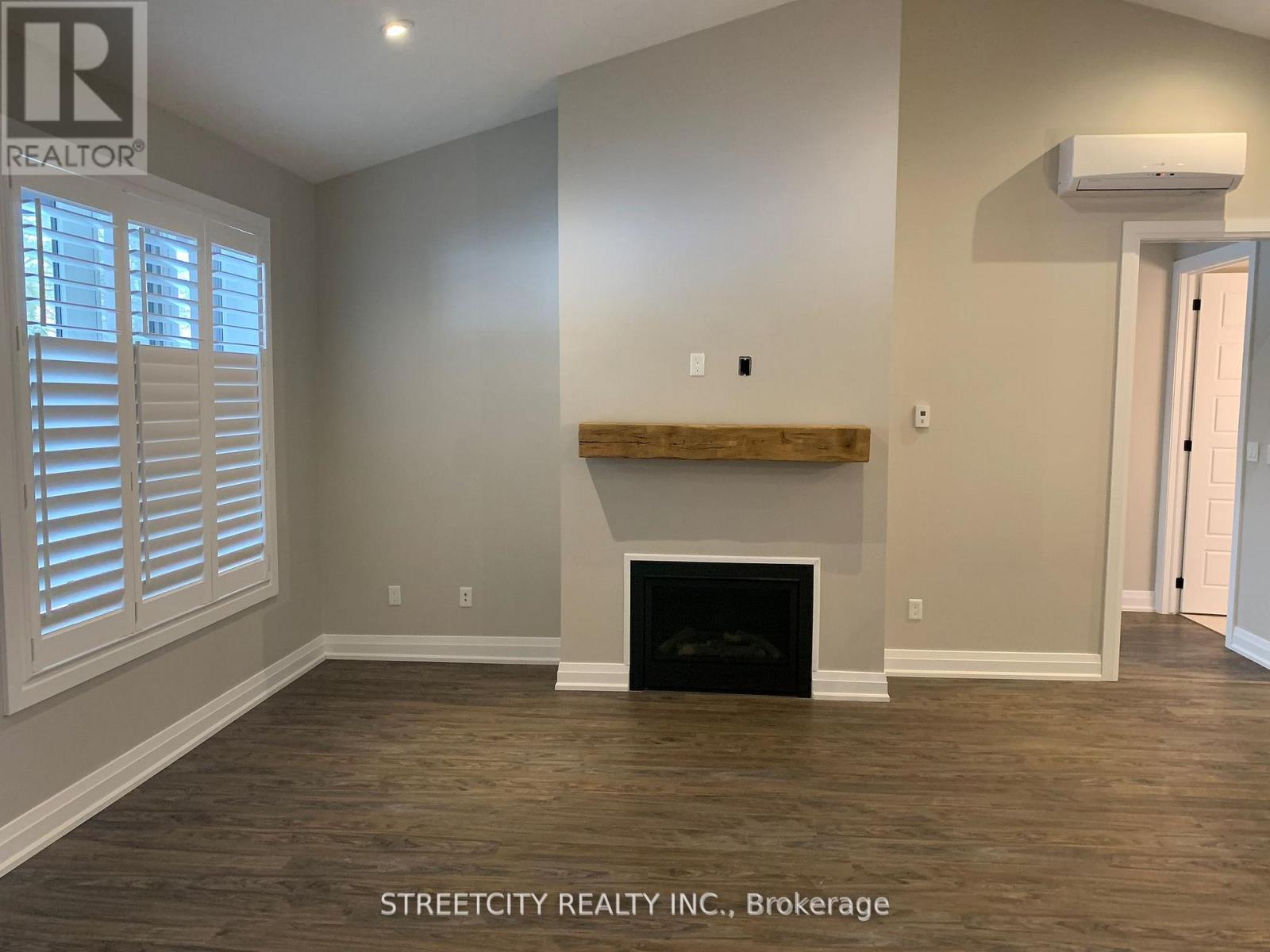 A room with a fireplace and wooden floors.