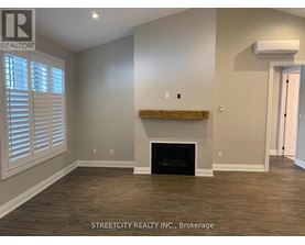 A room with a fireplace and wooden floors.