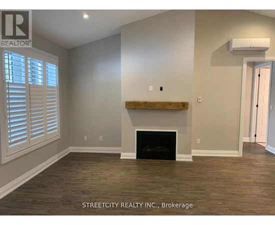 A room with a fireplace and wooden floors.