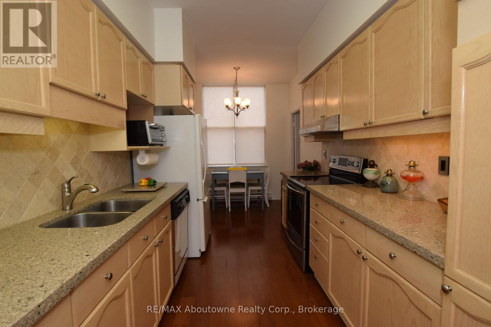 A kitchen with wooden cabinets and granite countertops.