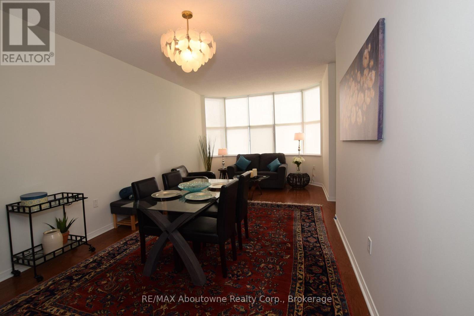 A dining room with a table set for six people.