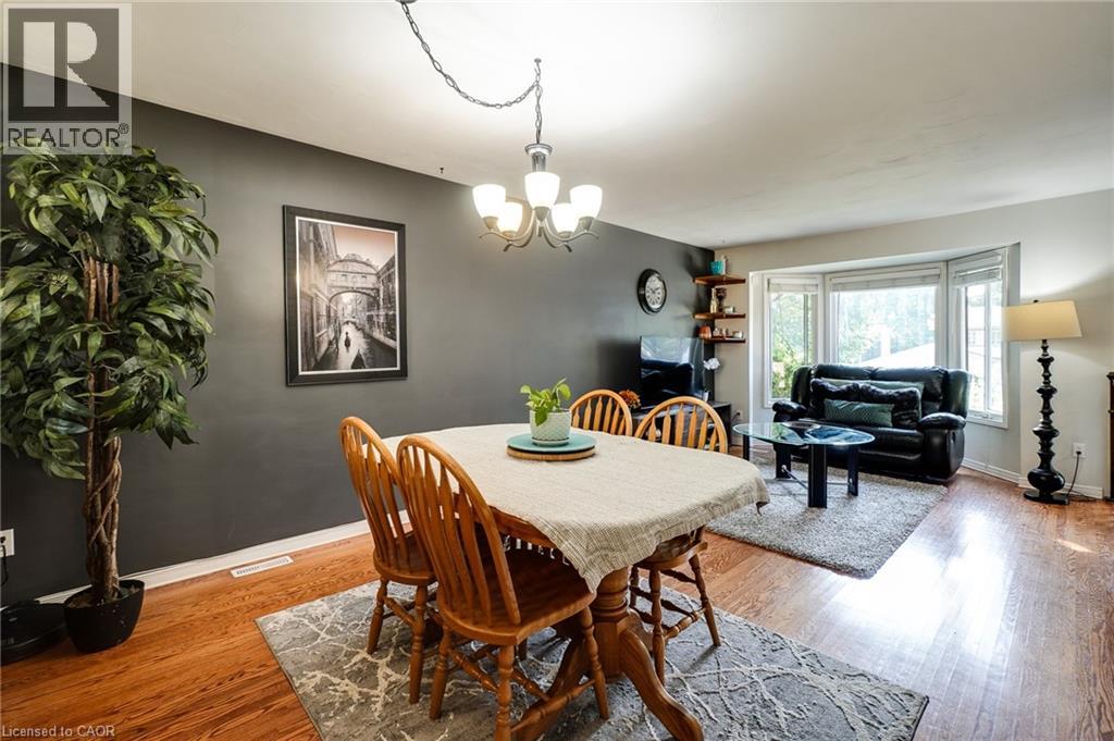 A dining room with a white table and chairs.