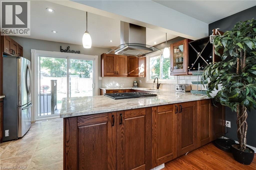A modern kitchen with wooden cabinets and a marble countertop.
