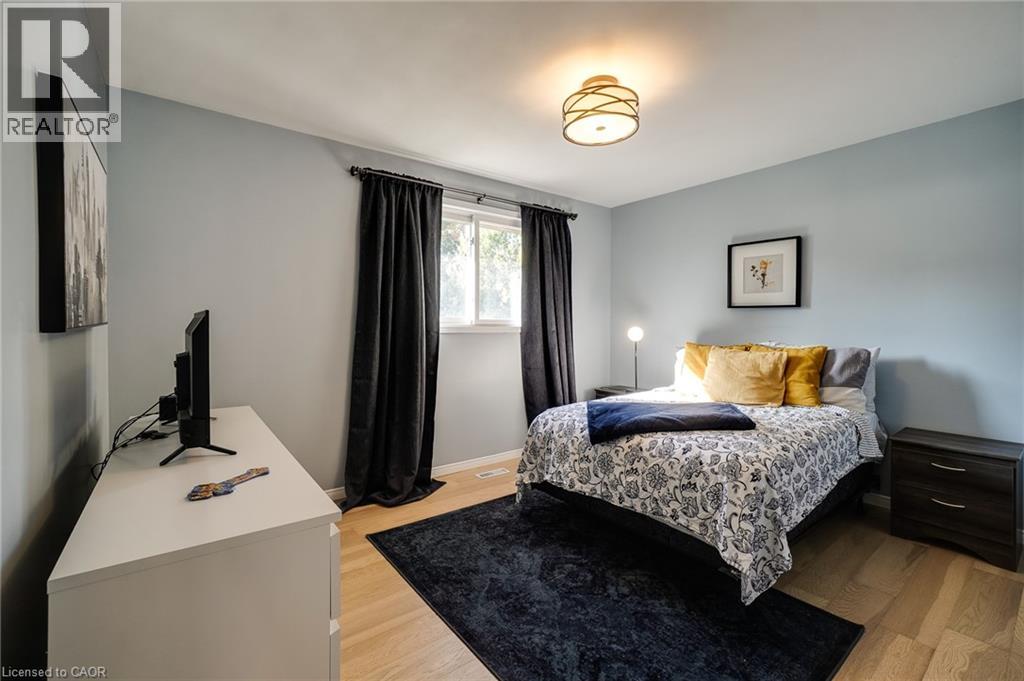 A bedroom with a bed, a television, and a rug.