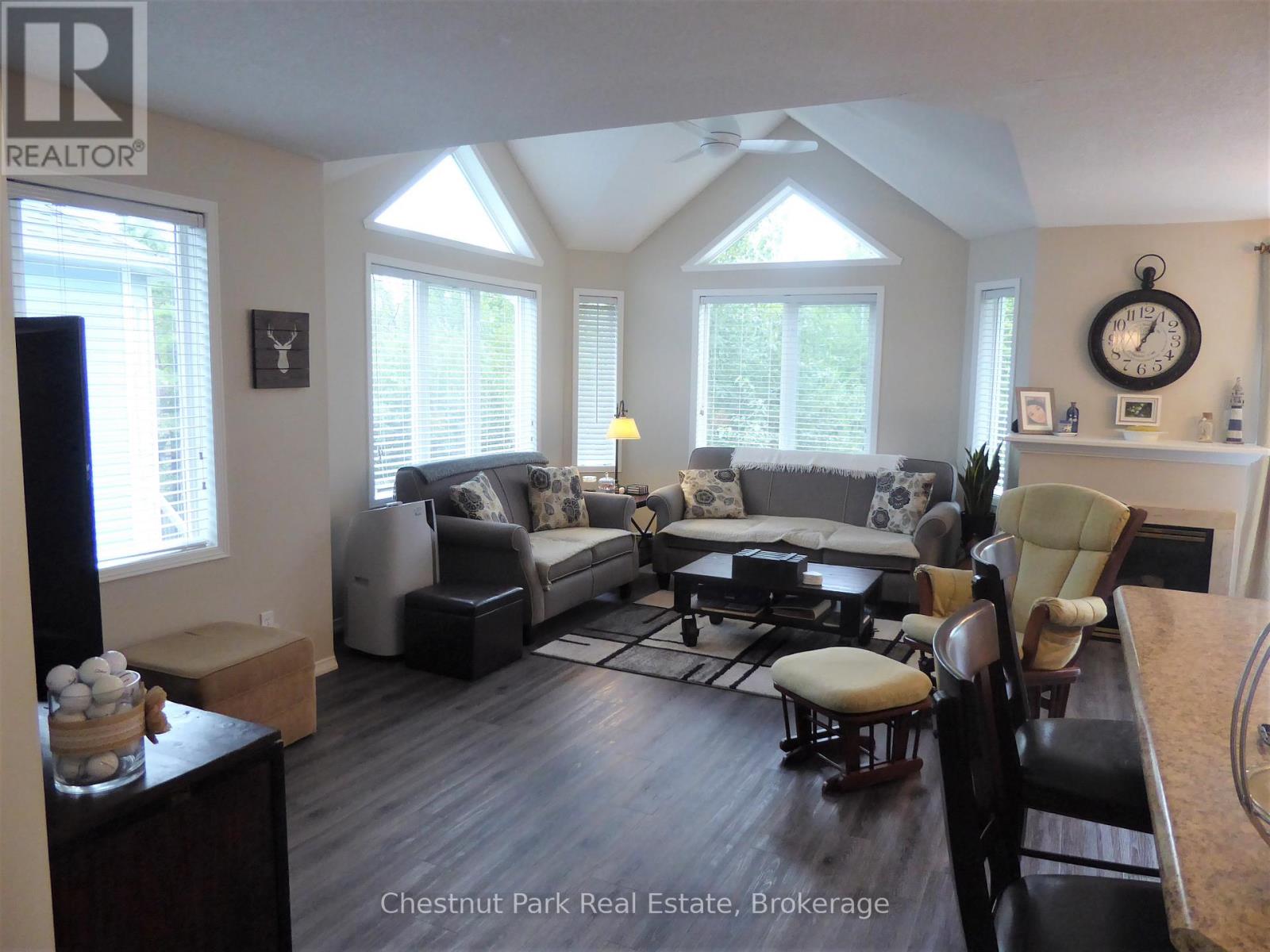 A living room with a couch, chairs, and a table.