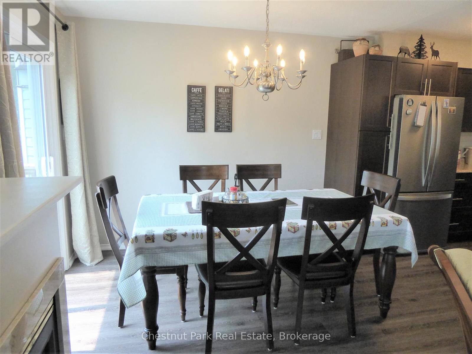 A dining room with a table set for four.