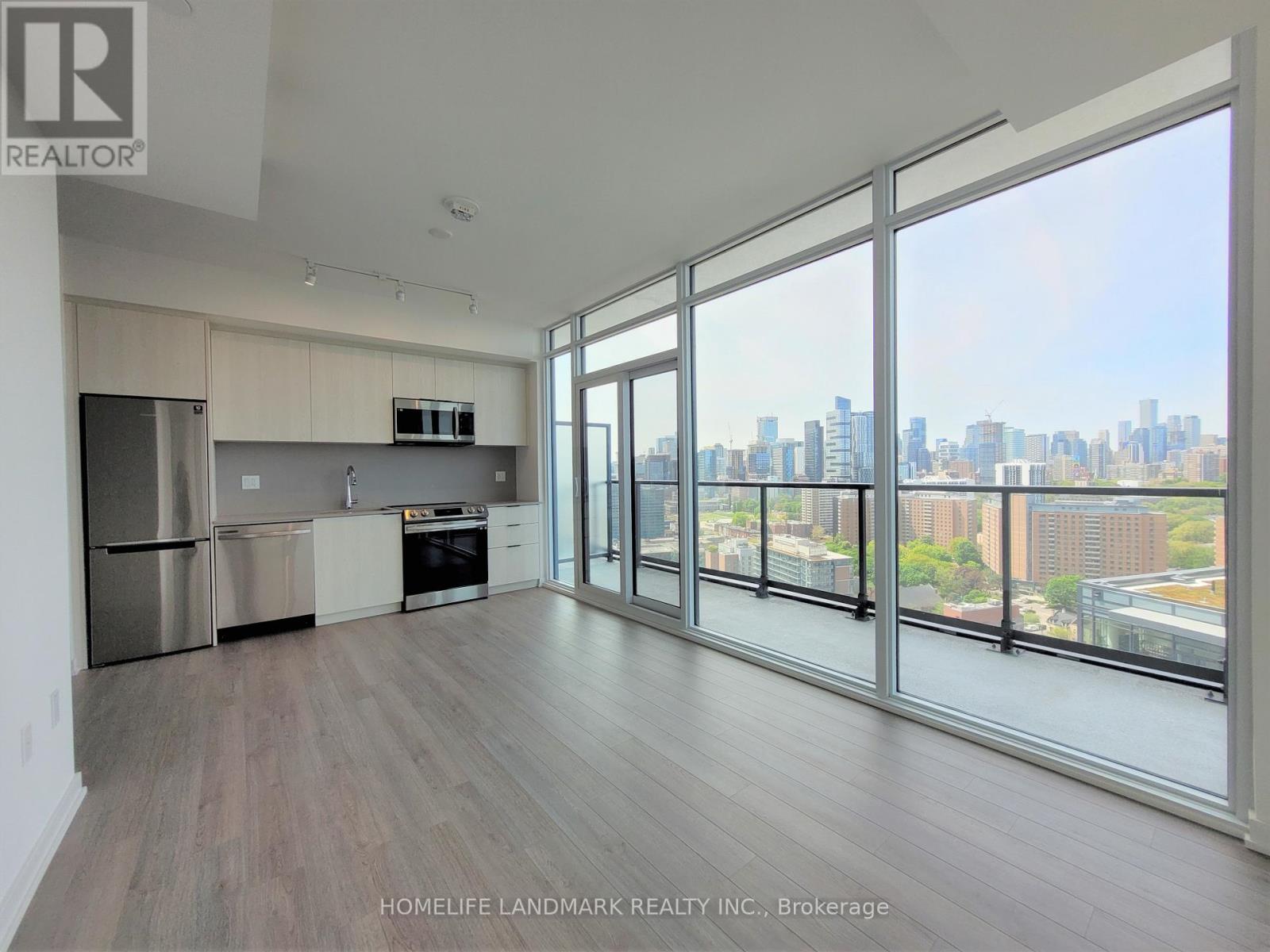 A spacious kitchen with a view of the city.