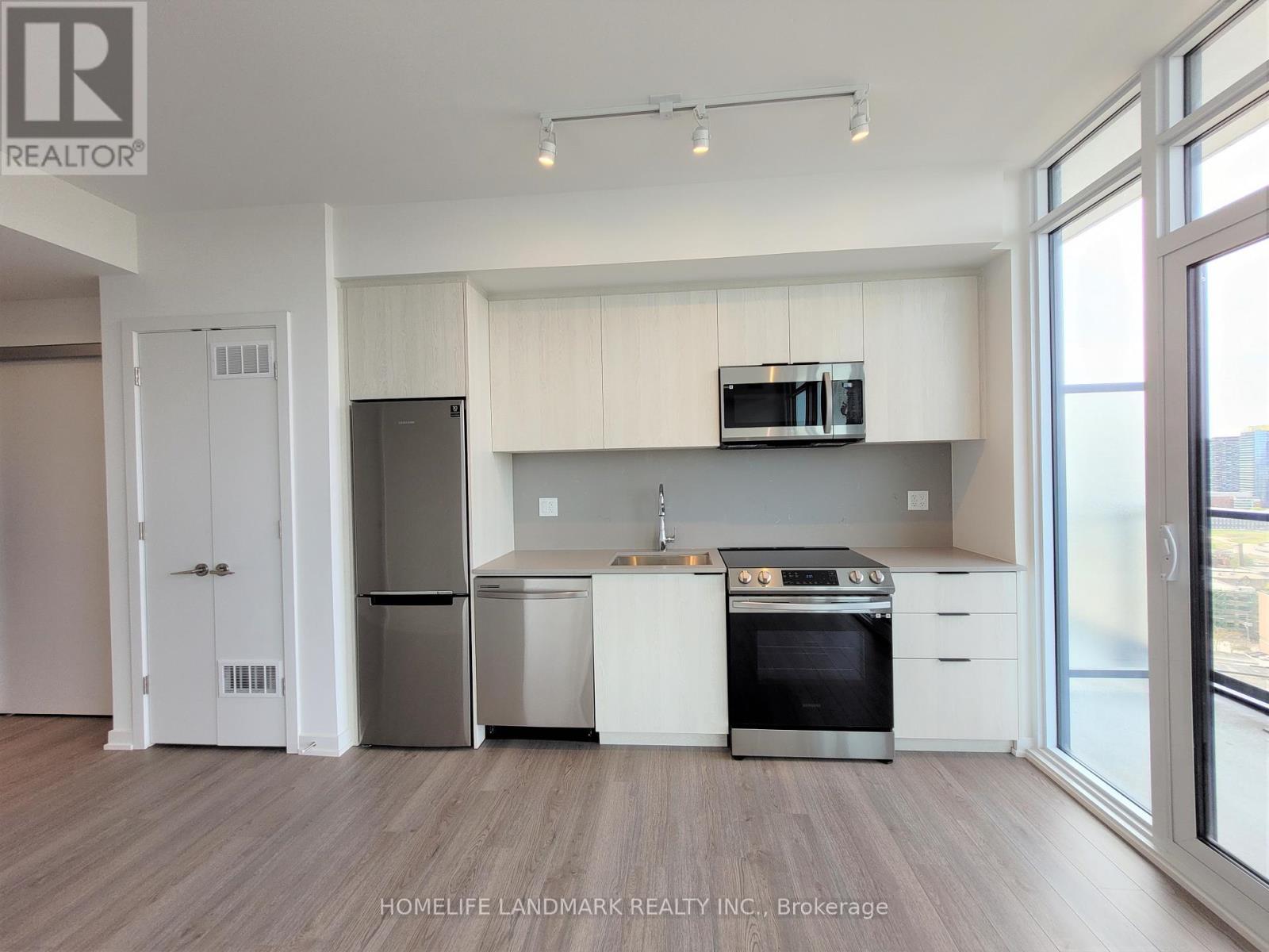 A kitchen with white cabinets and stainless steel appliances.