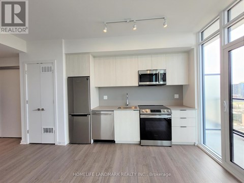 A kitchen with white cabinets and stainless steel appliances.