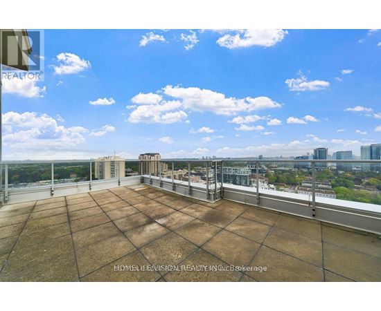 A rooftop with a large brown tiled surface and a metal railing.
