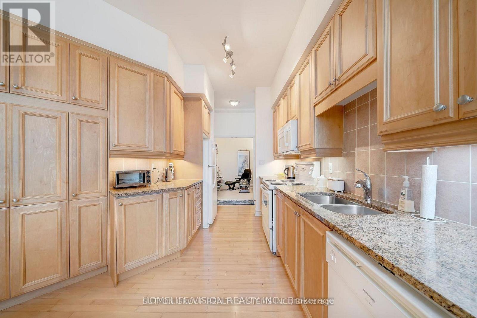 A kitchen with wooden cabinets and a white countertop.