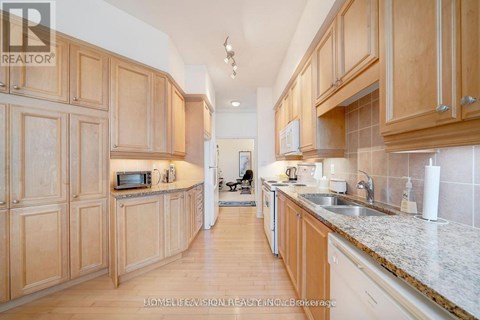 A kitchen with wooden cabinets and a white countertop.