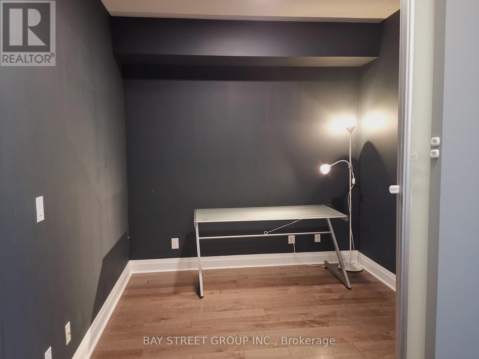 A bedroom with a bed and a lamp.