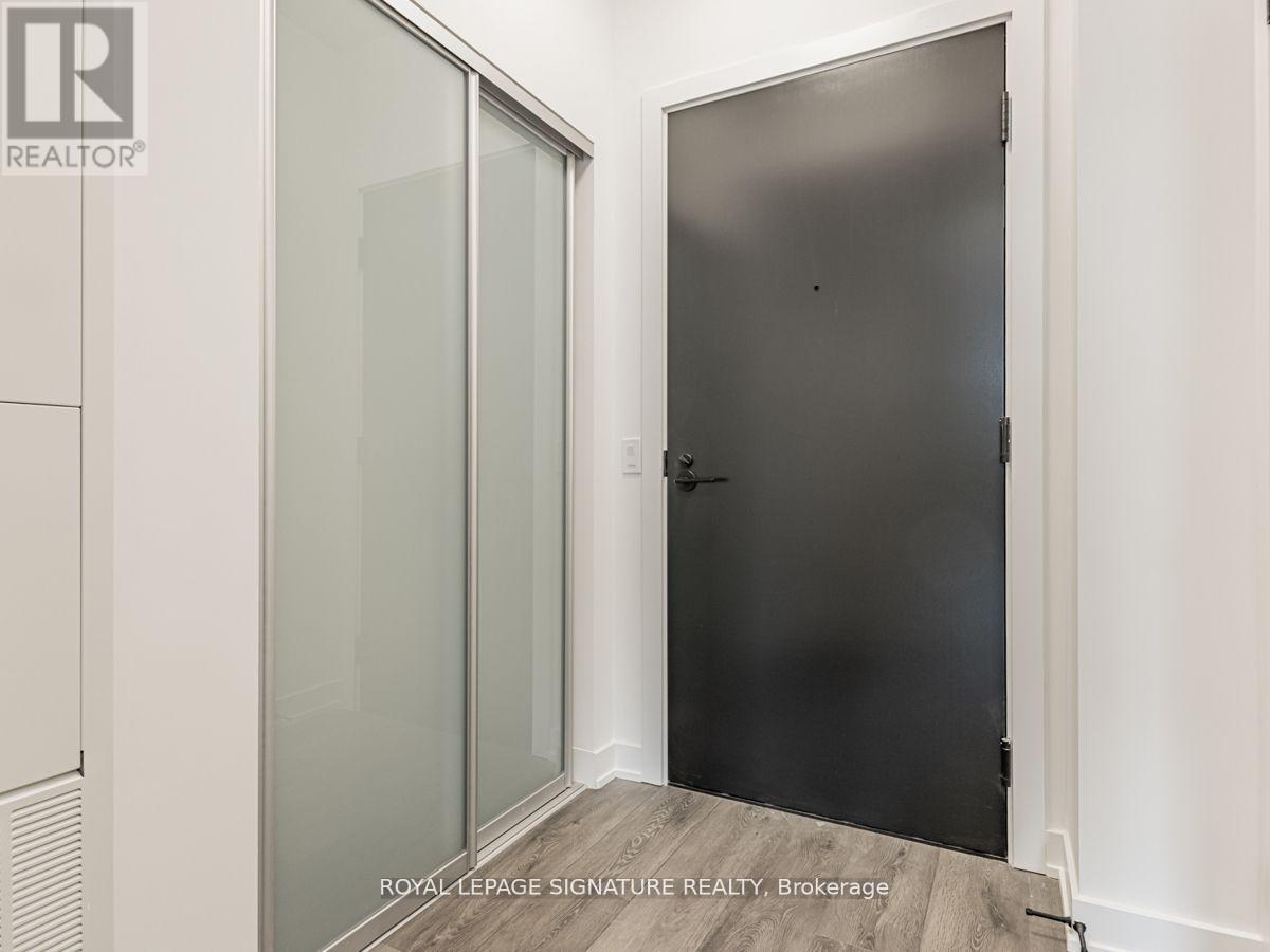 A room with a glass door and a black door.