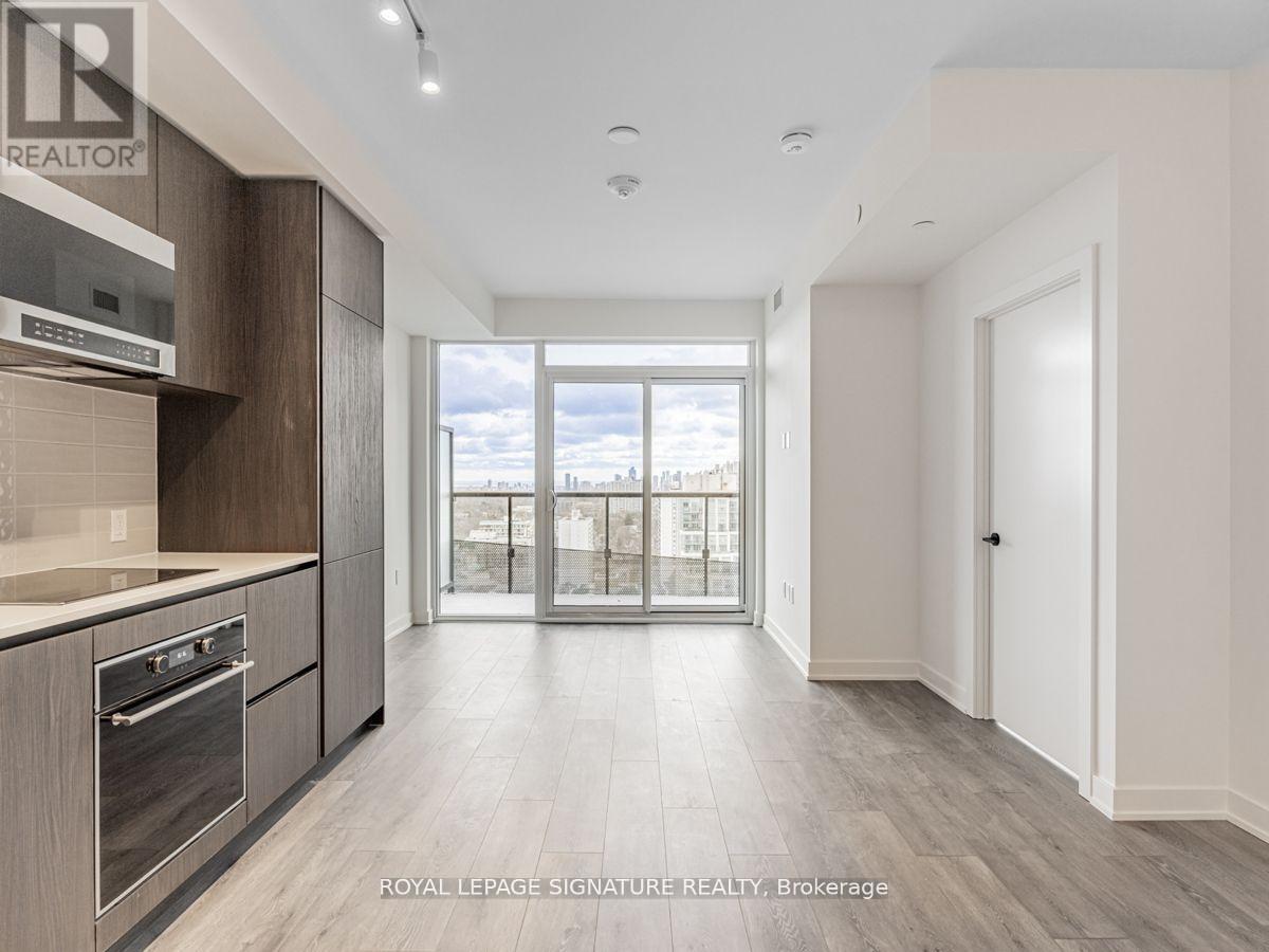 A spacious kitchen with a view of the city through the window.