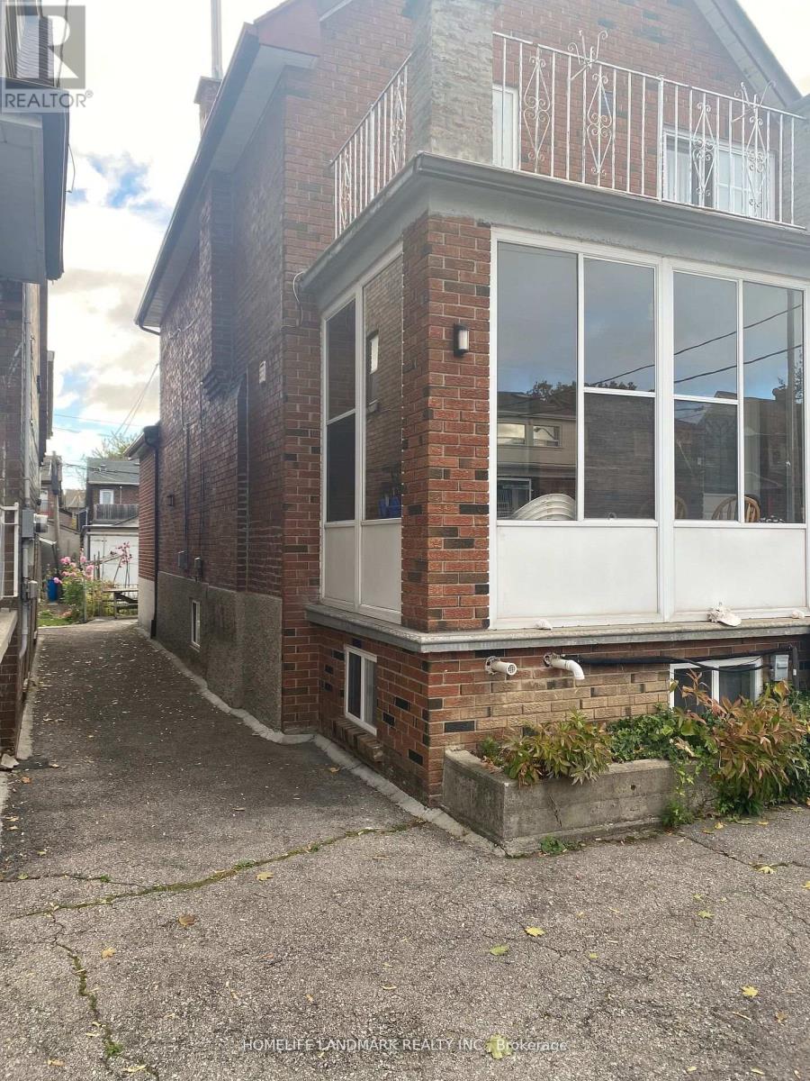 A brick house with a balcony and a window.