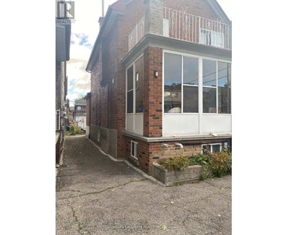 A brick house with a balcony and a window.