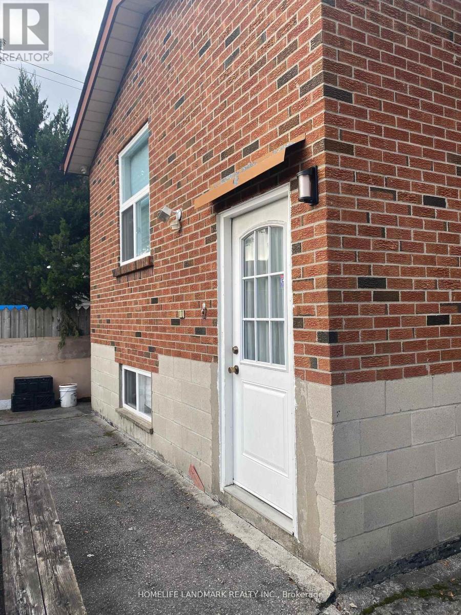 A brick house with a white door and a small porch.