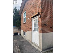A brick house with a white door and a small porch.