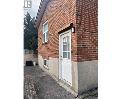 A brick house with a white door and a small porch.