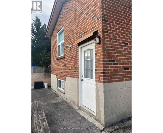 A brick house with a white door and a small porch.