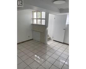 A tile floor in a room with a window and a door.