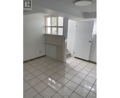 A tile floor in a room with a window and a door.