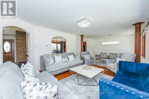 A living room with a white couch and a blue couch.