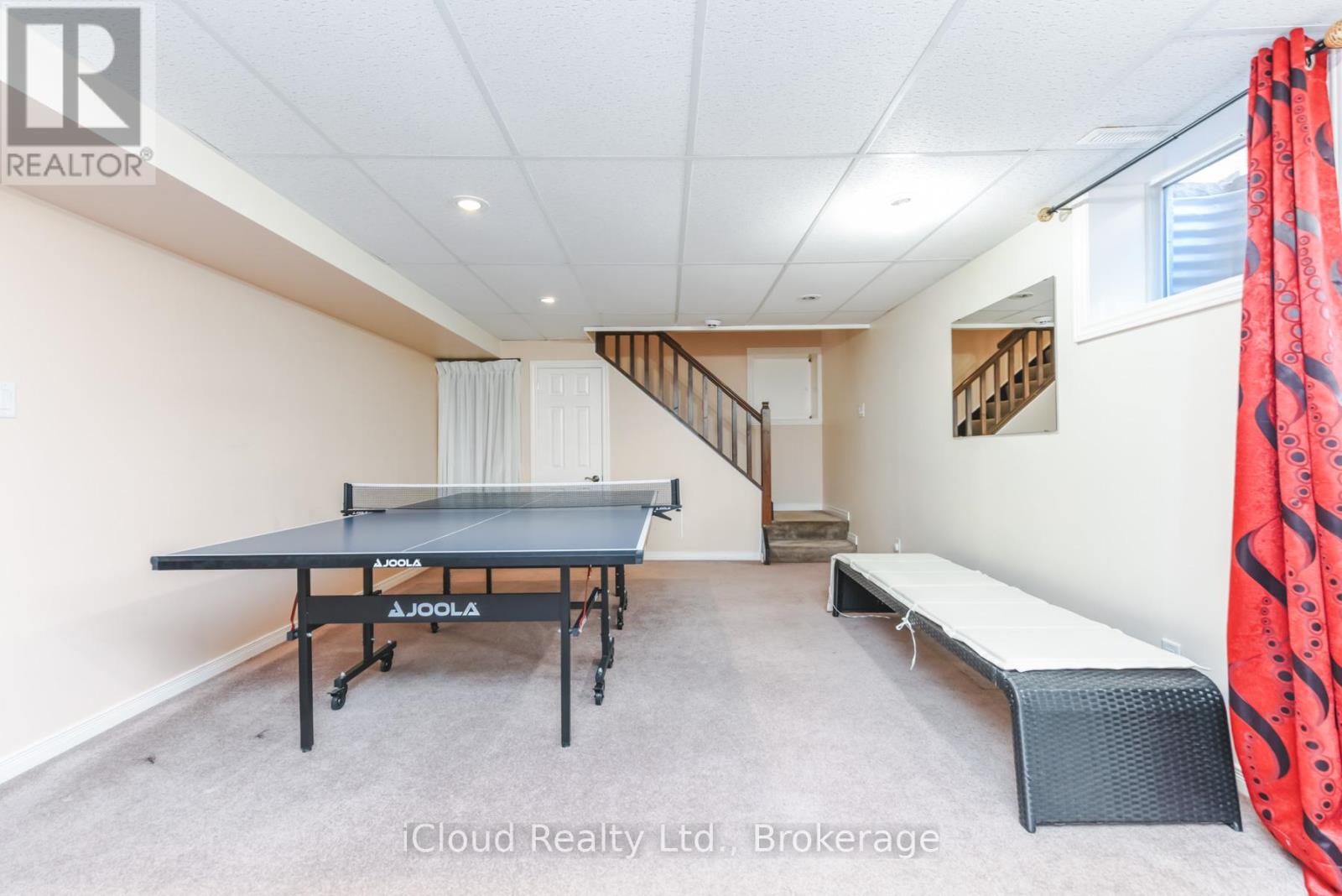 A room with a pool table and a bench.