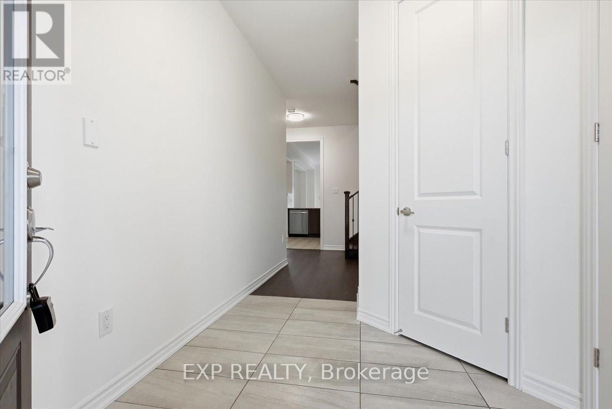 A hallway with white walls and a white door.