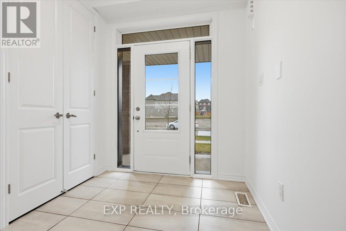 A white door with a glass window is in a room with white walls.