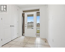 A white door with a glass window is in a room with white walls.